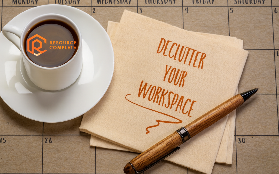 Resource Complete branded coffee cup, pen and napkin on a calendar with the words “Declutter Your Workspace” for a New Year blog.