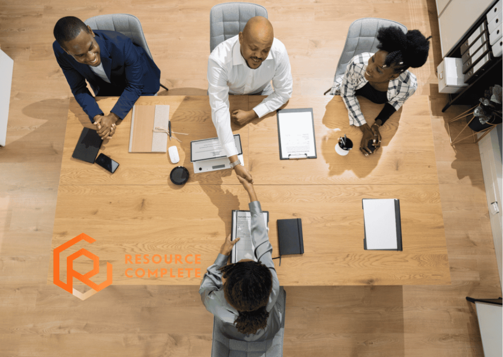 Small business staffing strategy meeting discussing permanent, temporary and outsourced employees